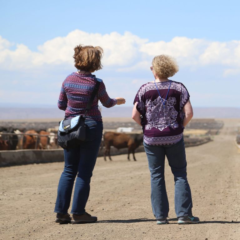 two woman talking on a ranch