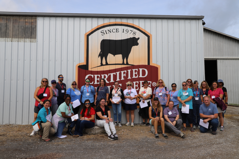 Teachers Standing in Front of Sign